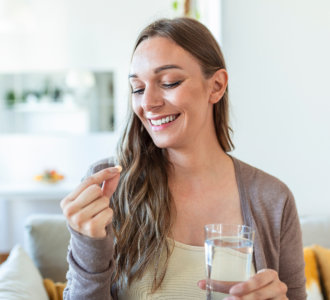 woman drinking a pill